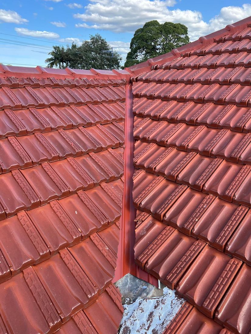 Restored terracotta tile roof with repointed ridge capping